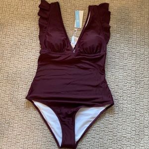 NWT beautiful burgundy size medium 1 piece suit